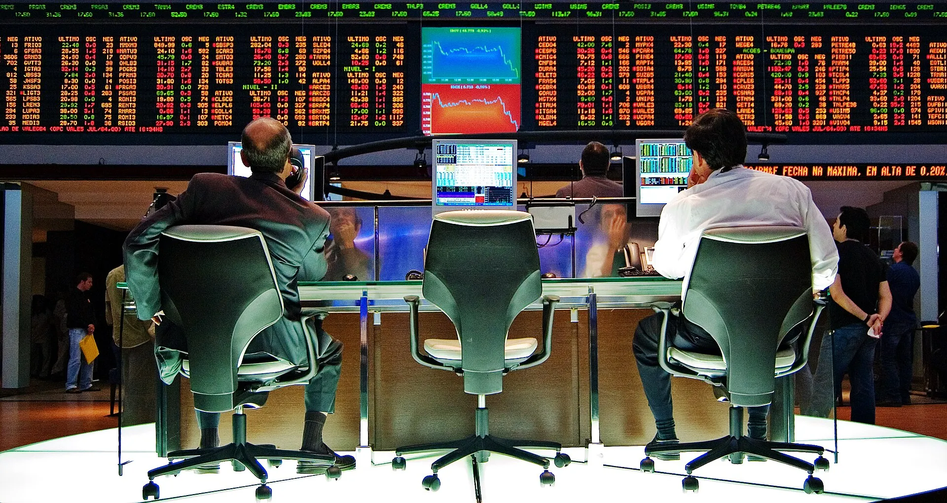 Operadores sentados de costas diante de painéis de cotações eletrônicos no pregão da Bolsa de Valores de São Paulo (Bovespa).