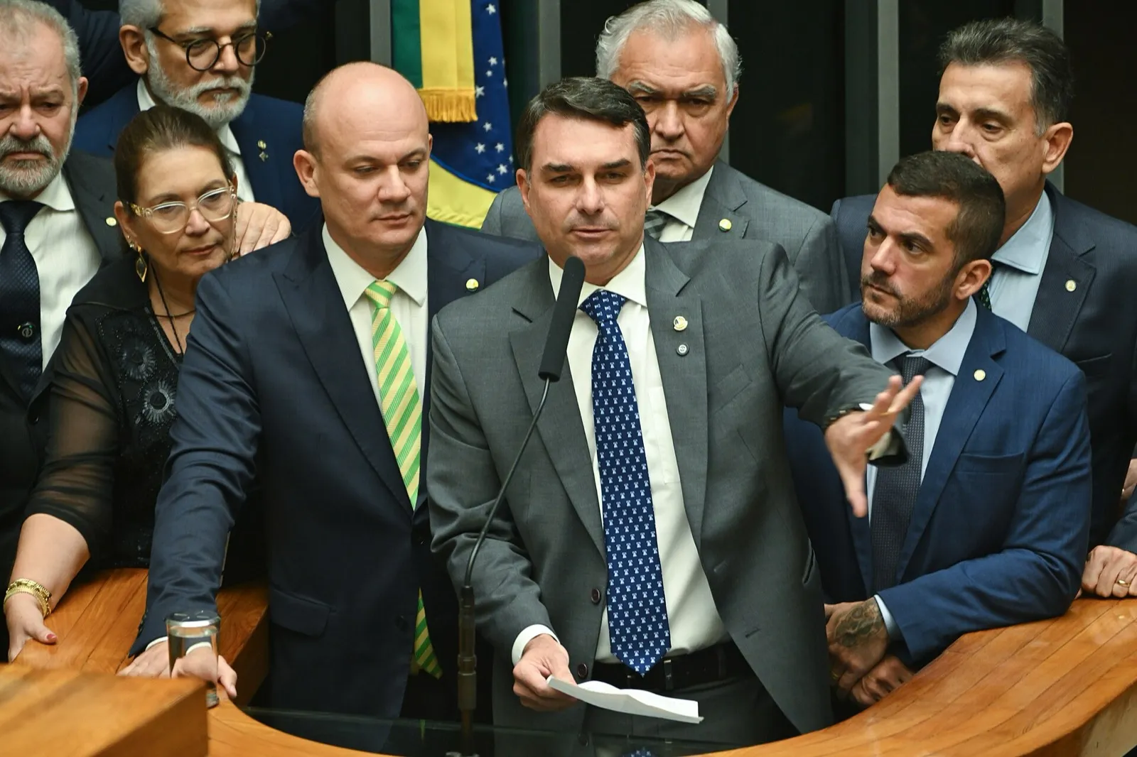 O senador Flávio Bolsonaro discursa à tribuna em sessão conjunta do Congresso Nacional, no plenário da Câmara dos Deputados, cercado por parlamentares.
